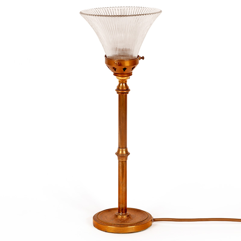 Art Deco cast brass table lamp on a textured, beaded circular base and column fitted with a prismatic glass shade (c.1925)